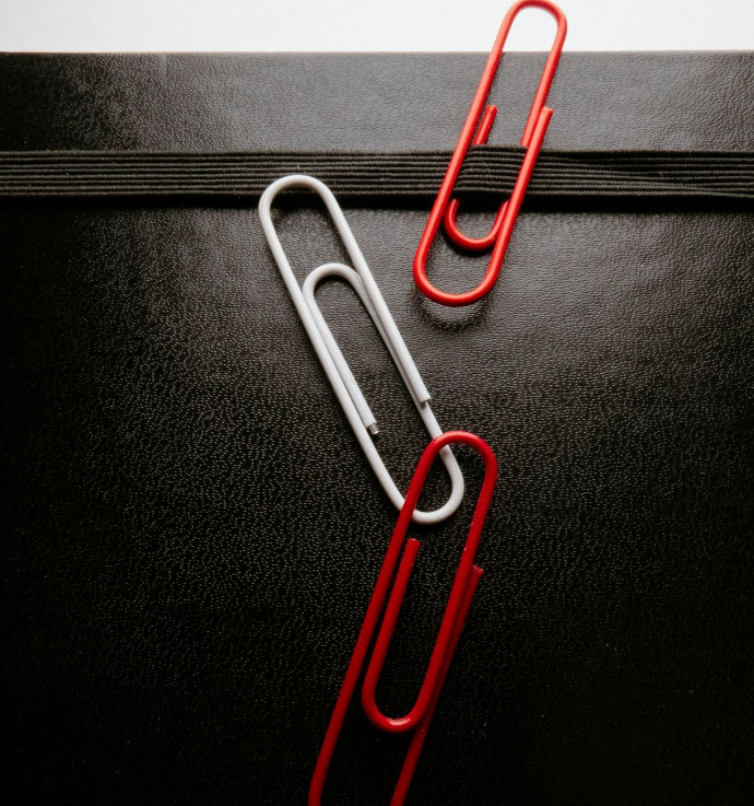 blue paper clip on black textile